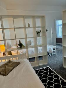a bedroom with a large white book shelf at The Santiago Suite - sleeps 10 in Southport