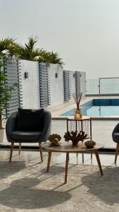 a living room with two chairs and a coffee table at The Ocean Villa in Fujairah