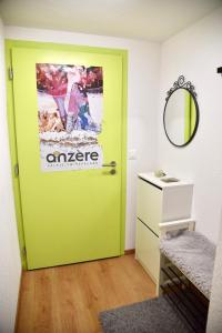 a green door in a room with a mirror at Anzère, appartement cozy au coeur des Alpes in Anzère