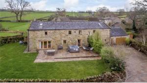 an aerial view of a stone house with a yard at Rookery barn in the outskirts of darley in Harrogate