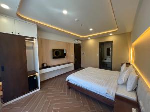 フーコックにあるTanya Phu Quoc Hotelのベッドとテレビが備わるホテルルームです。