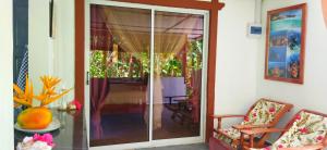 a room with a sliding glass door to a patio at Dan Zoranz Self Catering Guest House in La Digue