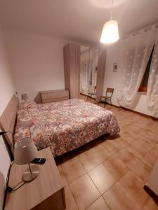 a bedroom with a bed and a table and chairs at B&B Da Nonna Lucia in Roccascalegna