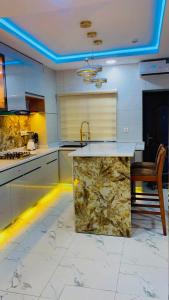 a kitchen with a marble counter and a sink at David Davids in Lagos