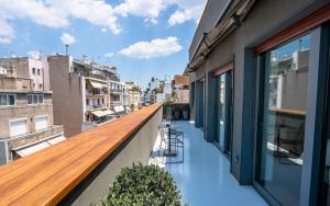 a balcony with a wooden bench on a building at Periscope in Athens