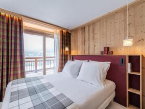 a bedroom with a large bed and a window at Chalet Courchevel, 7 pièces, 10 personnes - FR-1-568-42 in Courchevel