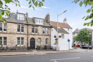 a house on the corner of a street at Stylish Apartment - Sleeps 4 - South Street St Andrews in St. Andrews