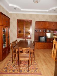 a dining room with a wooden table and chairs at Ineza's Guest House in Stepantsminda