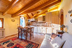 a kitchen with a couch and a table in a room at Happy Guest Apartments - Alpin Charme Colere in Colere