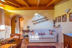 a living room with a couch and a table at Happy Guest Apartments - Alpin Charme Colere in Colere