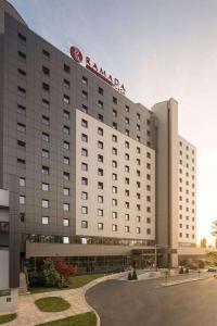 a hotel building with a sign on top of it at Ramada Plaza by Wyndham Bucharest Convention Center in Bucharest