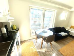 a living room with a table and a couch at DP Apartments Vaasa in Vaasa