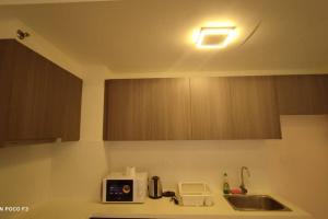 a kitchen counter with a sink and a microwave at HB1511-Cyberjaya-Netflix-Wifi-Parking-Pool , 3089 in Cyberjaya