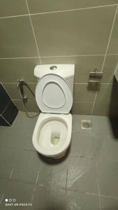 a bathroom with a white toilet in a stall at HB1511-Cyberjaya-Netflix-Wifi-Parking-Pool , 3089 in Cyberjaya