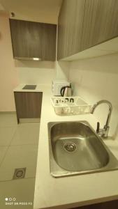 a kitchen counter with a sink in a kitchen at HB1511-Cyberjaya-Netflix-Wifi-Parking-Pool , 3089 in Cyberjaya