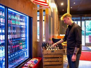 a man standing in front of a cooler in a store at ibis Berlin City Potsdamer Platz in Berlin