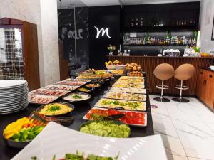 a buffet line with many plates of food at Mercure Opole in Opole