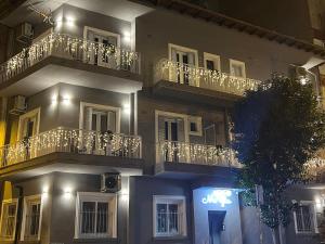 a building with balconies and a sign on it at night at MeYia studios in Thessaloniki