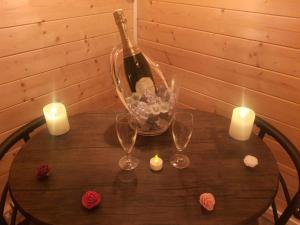 - une table avec une bouteille de vin et des bougies dans l'établissement Le temps suspendu, à Trèbes