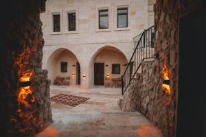 a stone building with a staircase and a fire place at DAPHNE CAVE HOTEL in Avanos