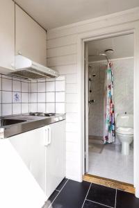 a kitchen with a sink and a toilet in a bathroom at Hallingparken in Gol