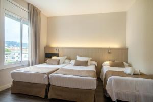 Posteľ alebo postele v izbe v ubytovaní Hotel Alga