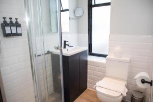 a bathroom with a toilet and a sink and a shower at Park Inn by Radisson Bournemouth in Bournemouth +37 photos