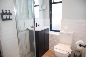 a bathroom with a toilet and a sink and a shower at Park Inn by Radisson Bournemouth in Bournemouth