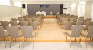 a room with rows of chairs and a podium at Park Inn by Radisson Bournemouth in Bournemouth