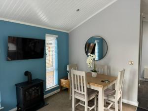 a dining room with a table and a mirror at V+B Hygge in Windermere