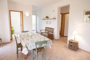 a dining room with a table and chairs at Appartamenti Villa Anna - Goelba in Capoliveri