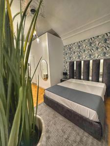 a bedroom with a bed and a potted plant at Boutique Rooms B&B in Catania