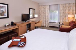 a hotel room with a bed and a television at Wingate by Wyndham Steubenville in Steubenville