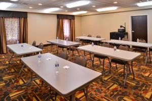 a conference room with tables and chairs and a podium at Wingate by Wyndham Steubenville in Steubenville
