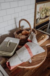 a basket of eggs and a basket of bread on a counter at Green Gables B&B in Cygnet