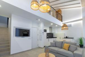 a living room with a couch and a tv at Ca Celieta Beach IV in Valencia
