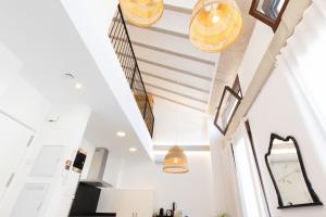 a staircase in a house with white walls and ceilings at Ca Celieta Beach IV in Valencia