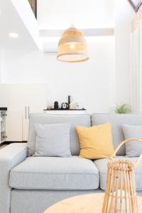 a blue couch with yellow pillows in a living room at Ca Celieta Beach IV in Valencia