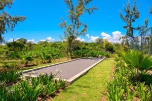 a road in a park with grass and trees at Ocean Grand Gaube with LOV in Grand Gaube