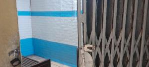a door to a shower with blue and white stripes at Hanoi Local Homestay in Hanoi
