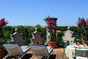 a patio with chairs and a table with a view at Hotel Excelsior Venice in Venice-Lido