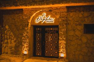 a sign above a door in a stone wall at DAPHNE CAVE HOTEL in Avanos