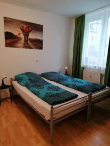 a bed in a bedroom with a picture on the wall at Monteurwohnung App 5 in Pirmasens