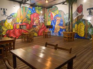a room with tables and chairs and a mural at Los Lagos Resort Hotel in Capiatá