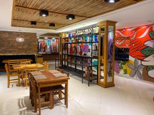 a restaurant with tables and chairs and a colorful wall at Los Lagos Resort Hotel in Capiatá