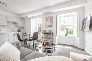 a living room with a couch and a table at Skye Sands - South Street Residence - St Andrews in St. Andrews
