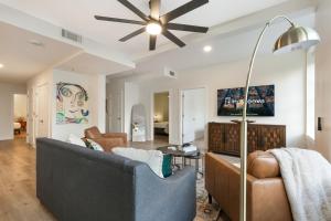 a living room with a couch and a ceiling fan at Spacious 4-Bed Condo steps from French Quarter in New Orleans