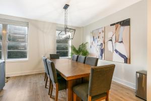 a dining room with a wooden table and chairs at Spacious 4-Bed Condo steps from French Quarter in New Orleans