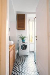 a bathroom with a washing machine and a toilet at Vaticano/Trastevere Floreal Suite in Rome +19 photos