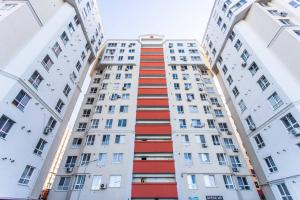 a tall white building with red stripes on it at Starrent Testimiteanu Kaufland MallDova shopping mall in Chişinău +30 photos